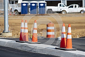 Orange Traffic Cones In Front of New Apartment Construction photo