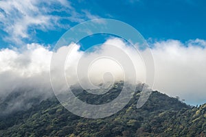 Horizontal shot of a hill full of trees and a beautiful landscape on a cloudy morning in the green hills of Escazu covered with photo
