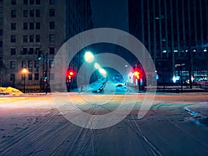 Horizontal shot of an illuminated crossroad in downtown Montreal, Canada during the night