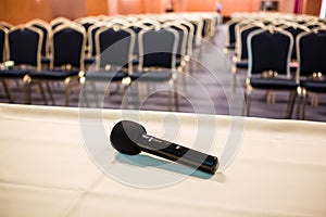 Horizontal shot of microphone and auditorium