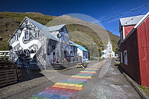 Horizontal shot of rainbow road in the beautiful rural town of Seydisfjordur, Iceland