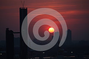 Horizontal shot of the sunset cloudy sky with skyscrapers at the Sukkhumvit district, Bangkok Thailand. photo