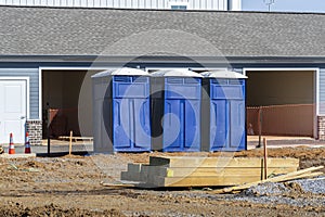 Three Porta Potties Or Outdoor Toilets At New Construction Site photo