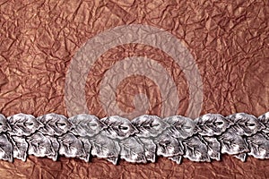 Horizontal silver leaves ornament on gold crumpled tissue paper