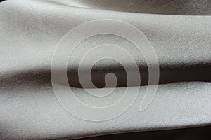 Horizontal soft folds on grey chiffon fabric