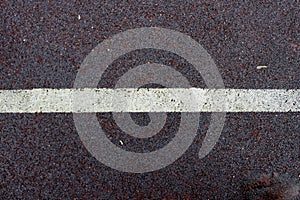 A white stripe on the old asphalt.