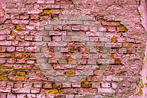 A horizontal texture of part of a old crashed brick wall in pink hue is on the photo