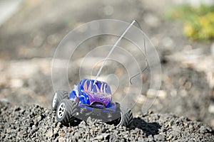 Horizontal of toy RC truck on dirt mound