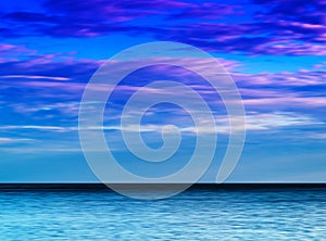 Horizontal vibrant ocean horizon with dramatic cloudscape backgr