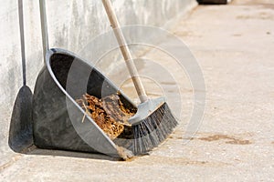 Horizontal View of Broom Full of Horse`s Manure and a Scoop at t