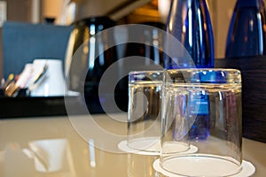 Horizontal View of a Composition of Two Glasses and a Blue Bottl