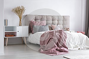 Pastel pink cozy bedroom with grey accents photo