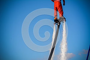 Horizontal View of Santa Claus on Flyboard on Blue Sky Background