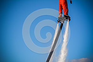 Horizontal View of Santa Claus on Flyboard on Blue Sky Background