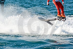 Horizontal View of Santa Claus on Flyboard on Blur Background