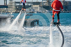 Horizontal View of Santa Claus on Flyboard on Blur Background