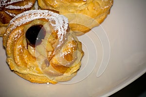 Horizontal View of Traditional Baked Italian Food Called Zeppole Made With Eggs, Cherries and Flour during Saint Joseph