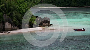 Horizontal view of tropical island with boat, Therese Island, Mahe, Seychelles.