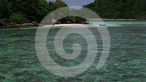 Horizontal view of tropical island with boat, Therese Island, Mahe, Seychelles.