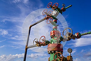 Horizontal view of a wellhead with valve armature. Oil and gas industry concept. Industrial site background. Toned