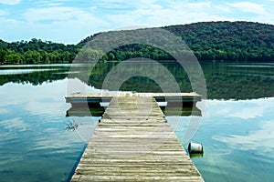 Horizontal view of the wooden boat pier on the peaceful Rockland Lake in New York State