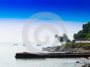 Horizontal vivid Indian beach quay with birds landscape backgrou