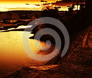 Horizontal vivid orange sunset near industial zone photo