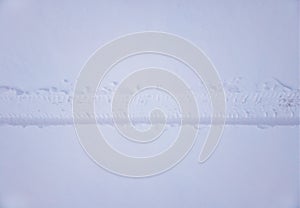 Horizontal wheel track on snow background