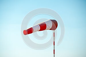 Horizontally flying windsock with blue sky in the background.