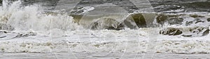 Horizontsl view of small wave curling in the Atlantic Ocean