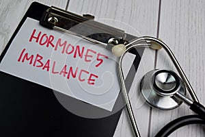 Hormones Imbalance write on sticky notes isolated on office desk photo