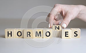 Hormones Word Written In Wooden Cube on white photo