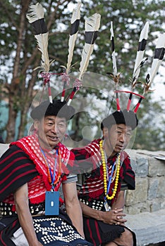 Hornbill Festival.Nagaland,India:1st December 2013 : Konyak Tribal Man sitting with his collegue at Hornbill Festival.