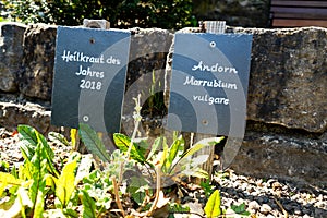 Horne plate slat sign with a stone wall in the background