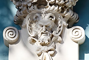 Horned head of Satyr,old house decoration,greek mythology photo