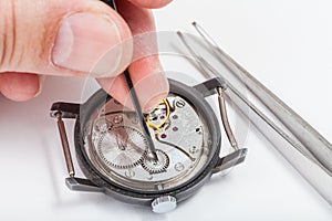 Horologer repairs old watch close up