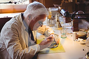 Horologist repairing a watch