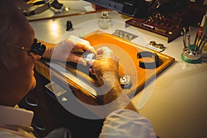 Horologist repairing a watch