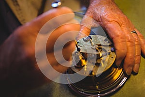 Horologist repairing a watch