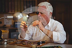 Horologist repairing a watch