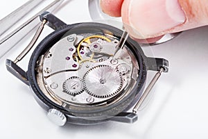 Horologist repairs old watch close up