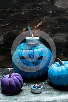 Horribly blue Halloween, painted blue pumpkins and candles