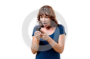 Horrified middle-aged woman looking at her mobile