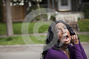 Horrified Young African American Woman in Purple Top