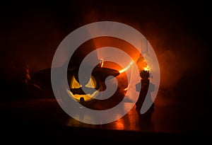 Horror Halloween concept. Burning old oil lamp in forest at night. Night scenery of a nightmare scene. Selective focus.