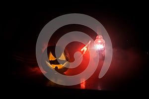 Horror Halloween concept. Burning old oil lamp in forest at night. Night scenery of a nightmare scene. Selective focus