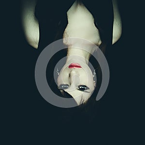 Horror Scene of a Woman Possessed, upside down photo