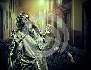 The horror shouting zombie girl on the dark street