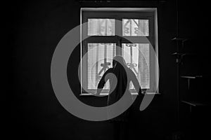 Horror woman in window wood hand hold cage scary scene halloween concept Blurred silhouette of witch. Horror theme