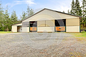 Horse arena exterior building with two lareg gates.